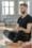 Calm adult man practicing meditation indoors, embracing peace and mindfulness.
